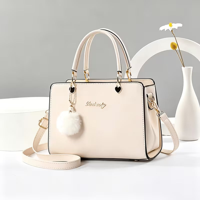 Sanika – Handtasche Mit Pompon Anhänger Und Schulterriemen
